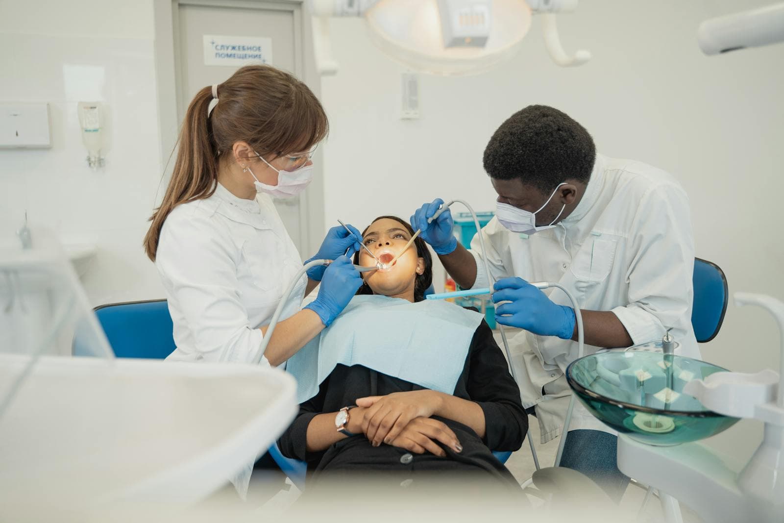 Dental team treating a patient during a root canal procedure